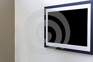 Blank photo frame on White wall in art gallery.