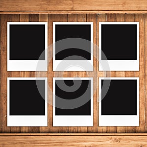 Blank photo frames on wood background