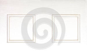 Blank photo frames on wooden white clolred wall