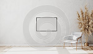 Blank picture frame in bright contemporary empty room interior with luxury white chair on wooden parquet floor and white