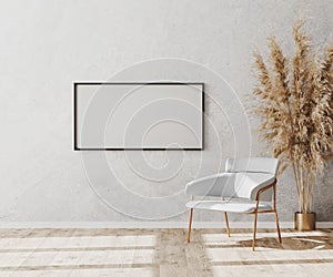 Blank picture frame in bright contemporary empty room interior with luxury white chair on wooden parquet floor and white