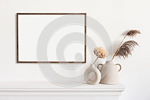 Blank picture frame mockup in home interior design. Living room, commode with vases.