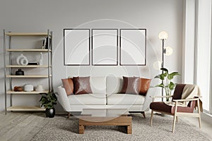 Blank 3 picture frame mockup on white wall. Modern living room design. View of modern Scandinavian style interior with