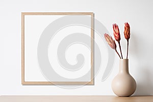Blank picture frame mockup on white wall, template for square artwork. View of modern minimal style interior with canvas