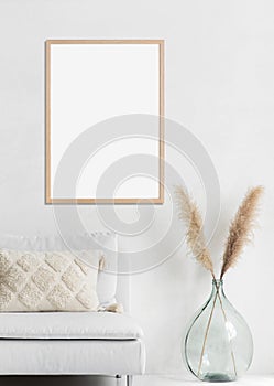 Blank picture frame mockup on white wall, vertical artwork template.