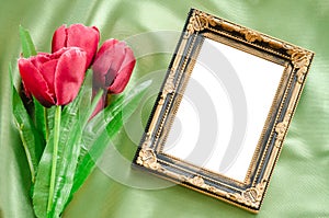 Blank Picture frames and red tulips flowers.