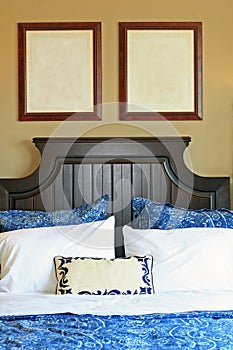 Blank pictures on wall above bed