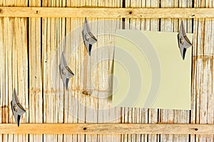 Blank piece of paper attached on an old house bamboo wooden wall.