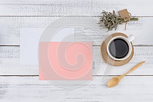 Blank pink card and white envelop with a cup of coffee