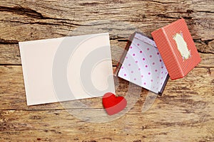 Blank pink greeting card with border frame and empty red present gift box with open cover