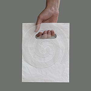 Blank plastic bag mock up holding in hand. Empty polyethylene pa