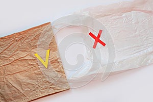 Blank plastic bag vs brown recyclable paper pack. Say no to plastic. Reduce, reuse and recycle concept.Eco friendly bag