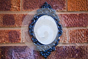 Blank plate on brick wall, English village