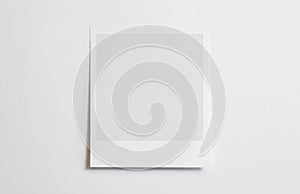 Blank polaroid photo frame with soft shadows tape isolated on white paper background as template for graphic designers