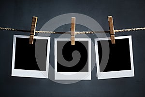 Blank polaroid photographs hanging on a clothesline