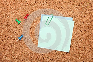 Blank postit note on cork notice board