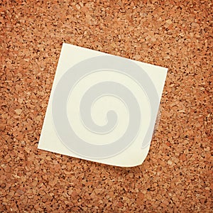 Blank postit note on cork wood notice board