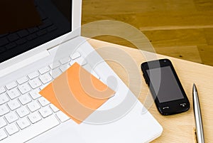 Blank postit note on white laptop keyboard