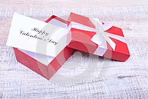 Blank present Valentine card on wooden background