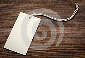 The blank price tag label on wooden background