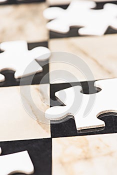 Blank puzzle pieces on chess board