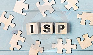 Blank puzzles and wooden cubes with the text ISP Internet Service Provider lie on a light blue background