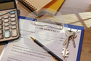 Blank real estate lease agreement and keys on office desk