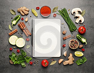 Blank recipe book and different ingredients on grey, flat lay. Space for text