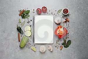 Blank recipe book and different ingredients on grey table, flat lay. Space for text