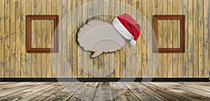 blank recycled paper speech bubble with Santa hat on wood background