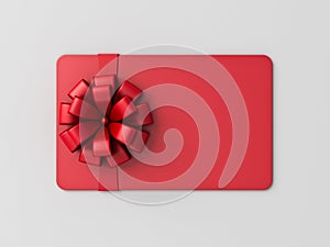 Blank red gift card or gift voucher with red ribbon bow on gray background with shadow minimal conceptual 3D rendering