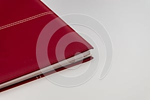 Blank red hardcover book on white background with copy