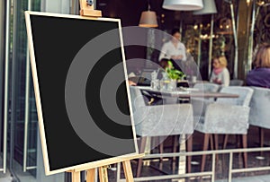 Blank restaurant menu blackboard with blury people photo