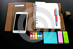 Blank ring binder planner with index tabs, mobile phone and note pads use for time management in personal or business
