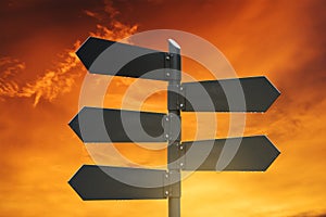 Blank road signpost, with sunset sky background