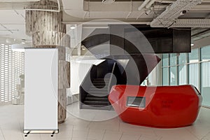 Blank roll up banner stand in contemorary office interior