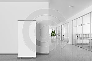 Blank roll up banner stand in modern office interior