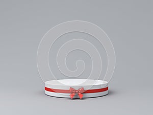 Blank round gift podium pedestal with red ribbon bow on light gray background minimal conceptual 3D rendering