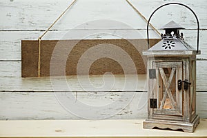 Blank rustic wood sign hanging with wooden lantern decorate summer background