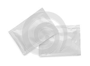 Blank sachets with wet wipes on white background, top view. Space for design