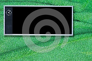 Blank score board on green grass background