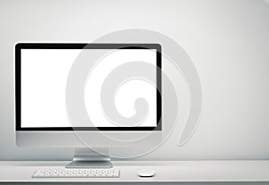 Blank screen computer display for mockup in office interior, Work desk with keyboard, mouse. Copy space on wall for text.