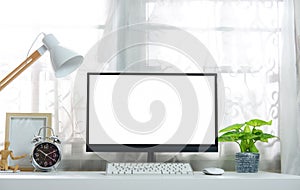 Blank screen on the desktop computer with house plant and office supplies, mockup