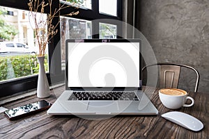 Blank screen laptop computer with mouse and smart phone on wooden table