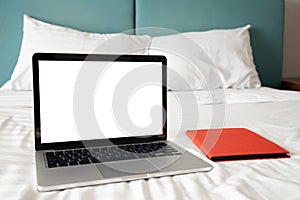 Blank screen  laptop, notebook on white bed