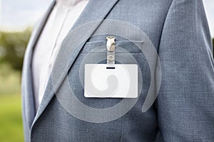 Blank security name tag on businessman suit pocket background