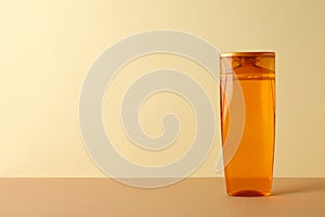 Blank shampoo bottle on beige background space for text