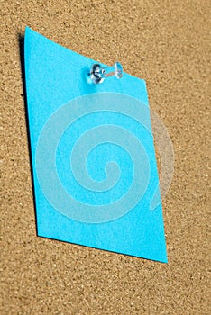 Blank sheet of blue paper on a bulletin board