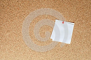 Blank sheet of paper for notes pinned to cork notice board