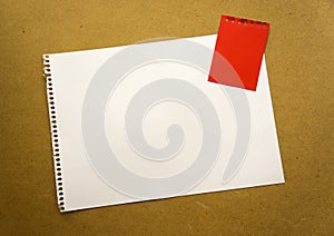 Blank sheet of paper space for design and lettering on a beautiful craft background red notepad sheet. Perforated sheet torn from